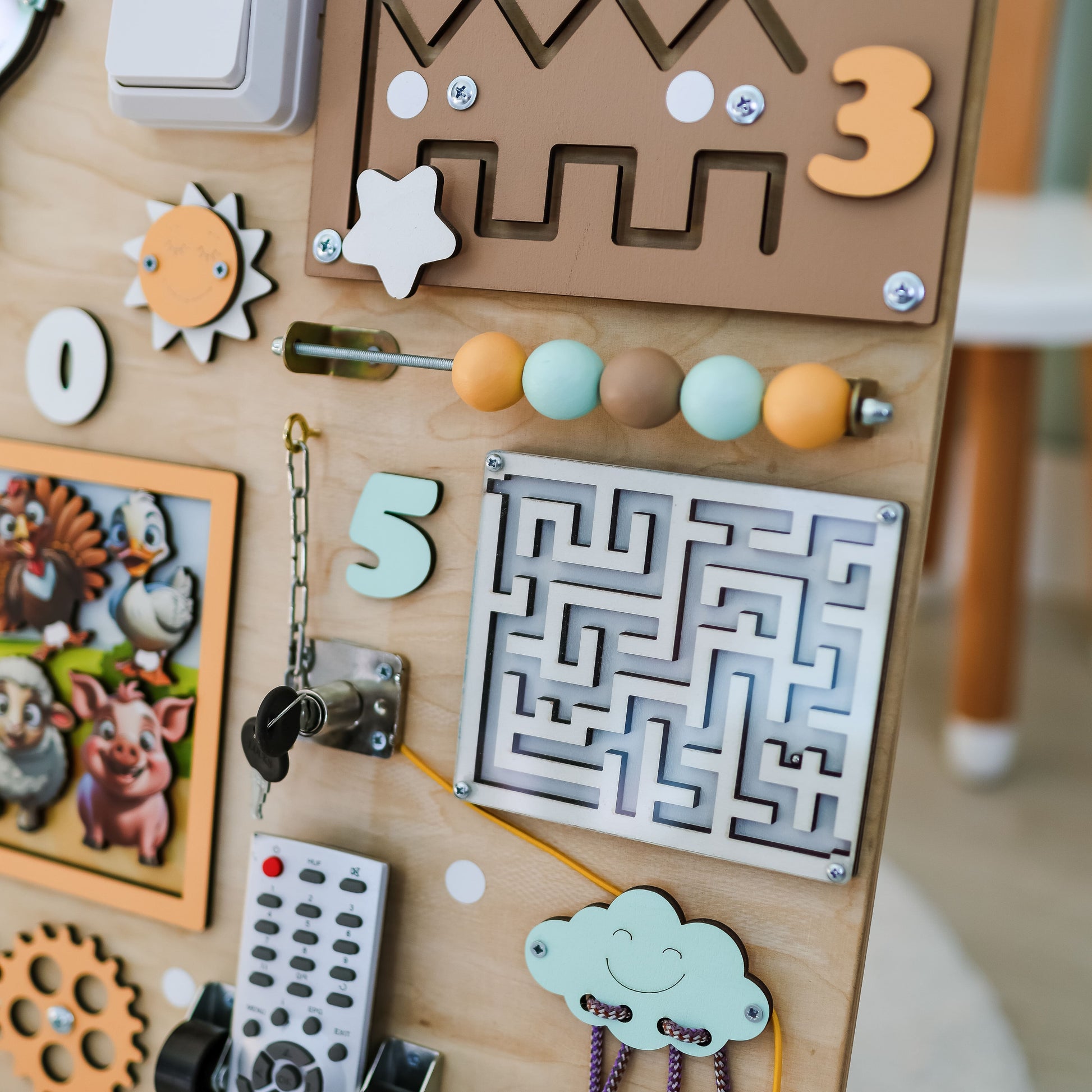 Handmade wooden busy board with cows, pigs, and horses for toddlers