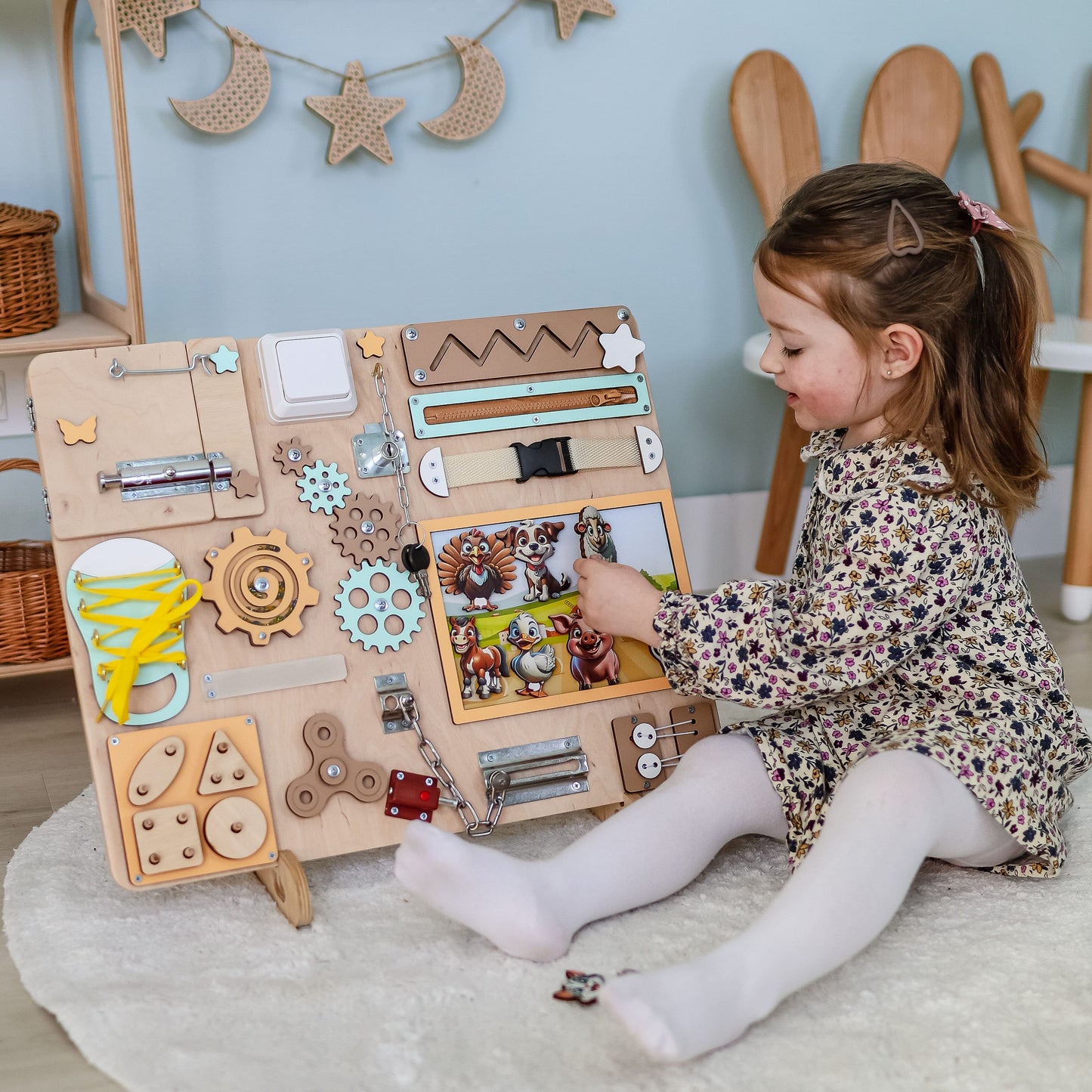 Toddler engaging with an educational farm busy board