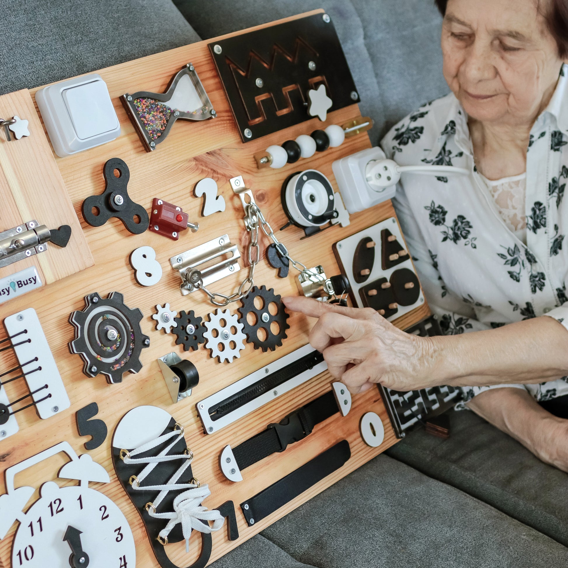 Close-Up of Large Busy Board Elements – Detailed image of the locks, switches, and tactile items on the large dementia care board