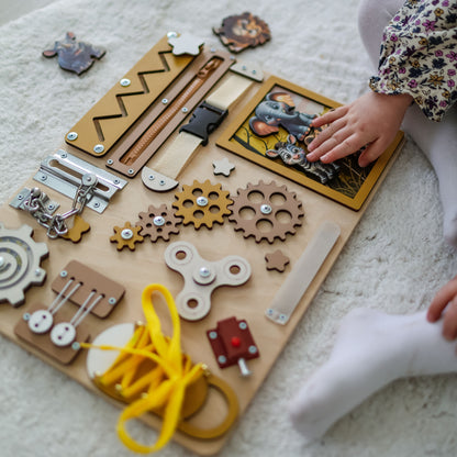 Toddler arranging magnetic safari animals on an interactive activity board