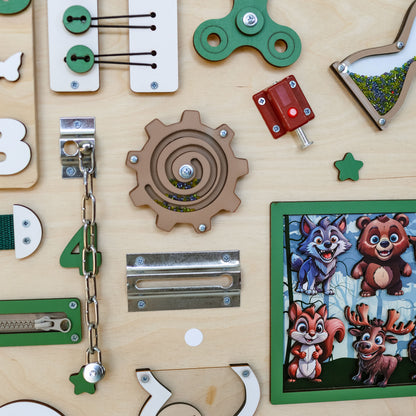 Handmade wooden busy board featuring a detailed woodland scene