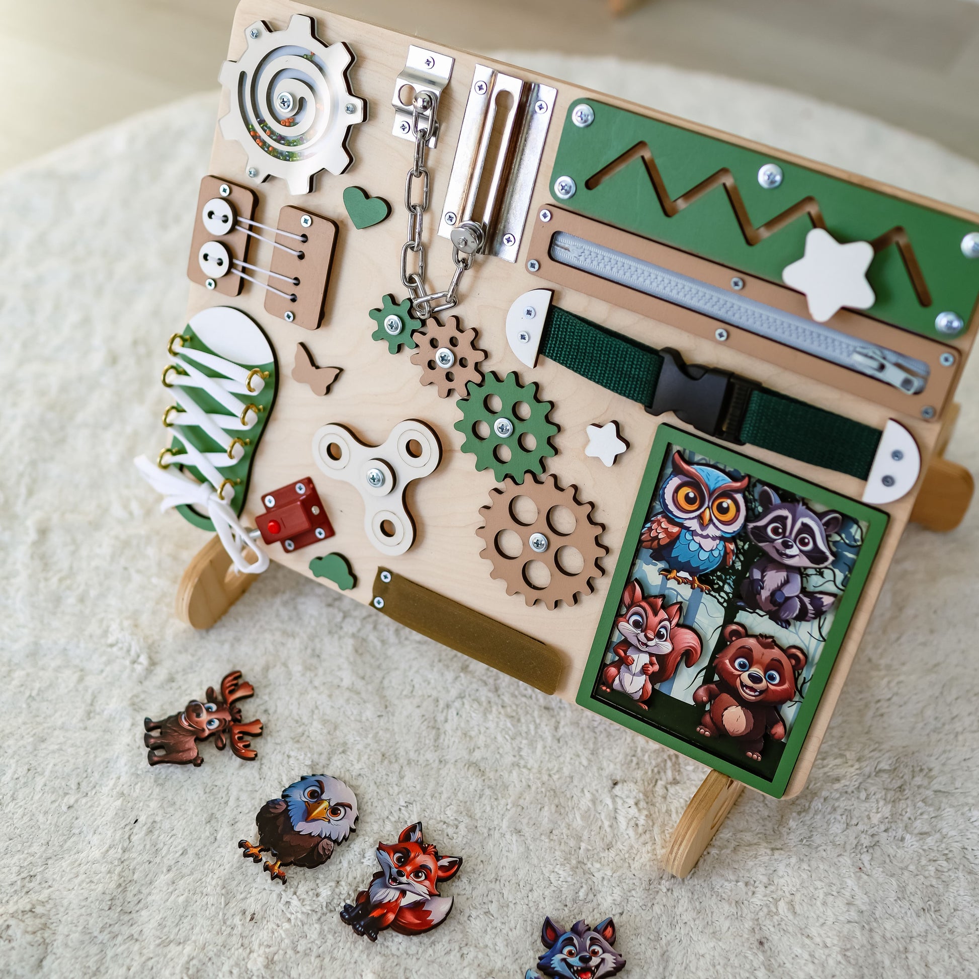Toddler arranging magnetic animals on a forest-themed busy board