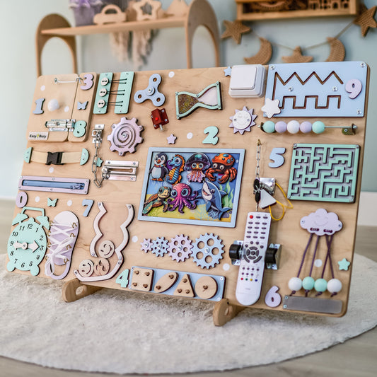 Close-up of removable magnetic fish, dolphins, and sharks on a wooden busy board