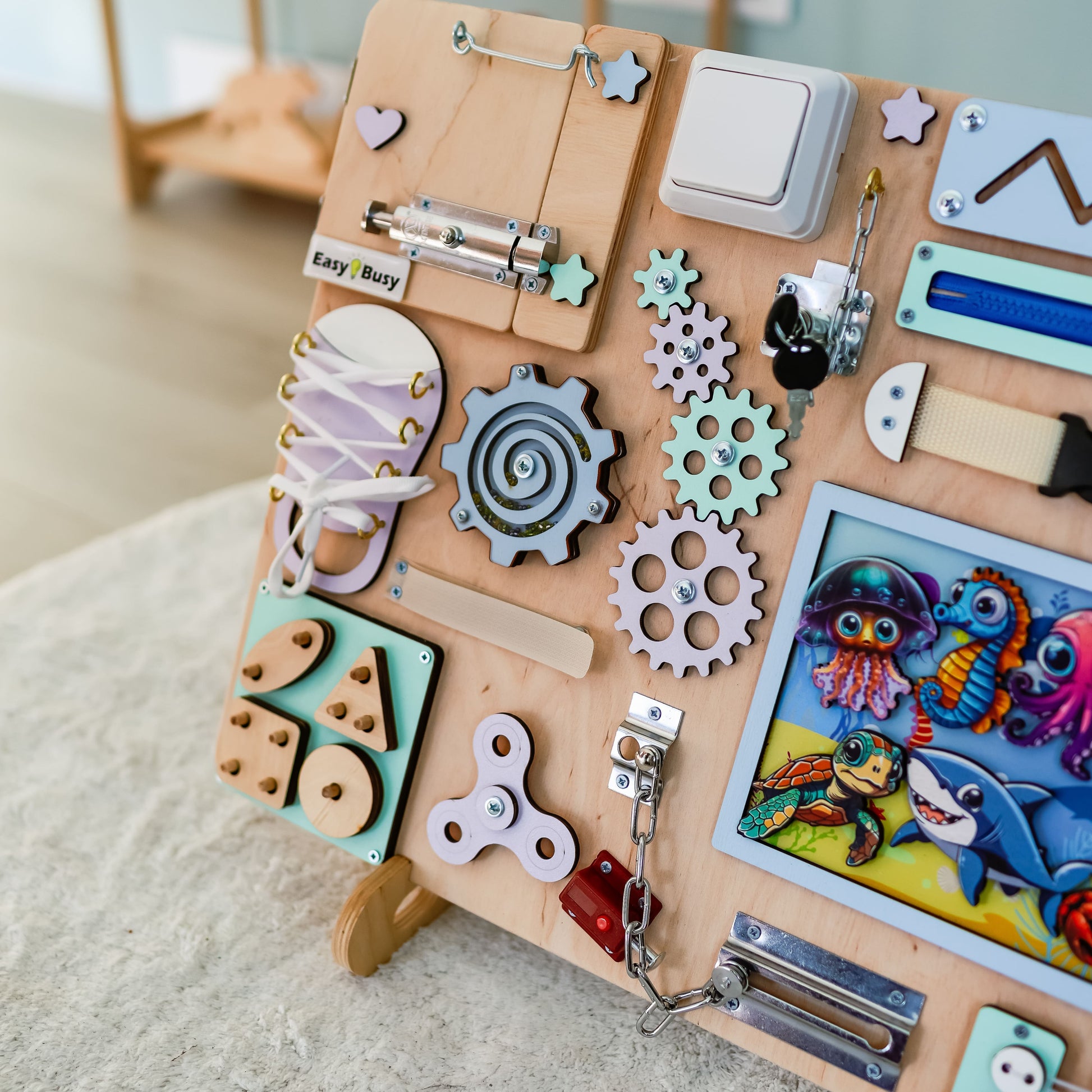 Montessori interactive sensory play board featuring dolphins, turtles, and fish