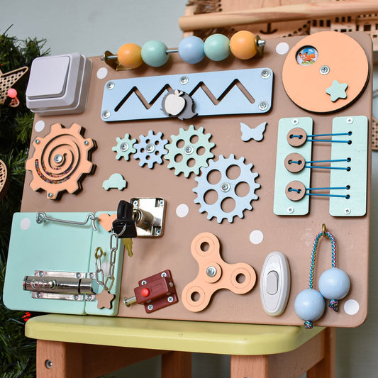 Personalized busy board with fine motor elements