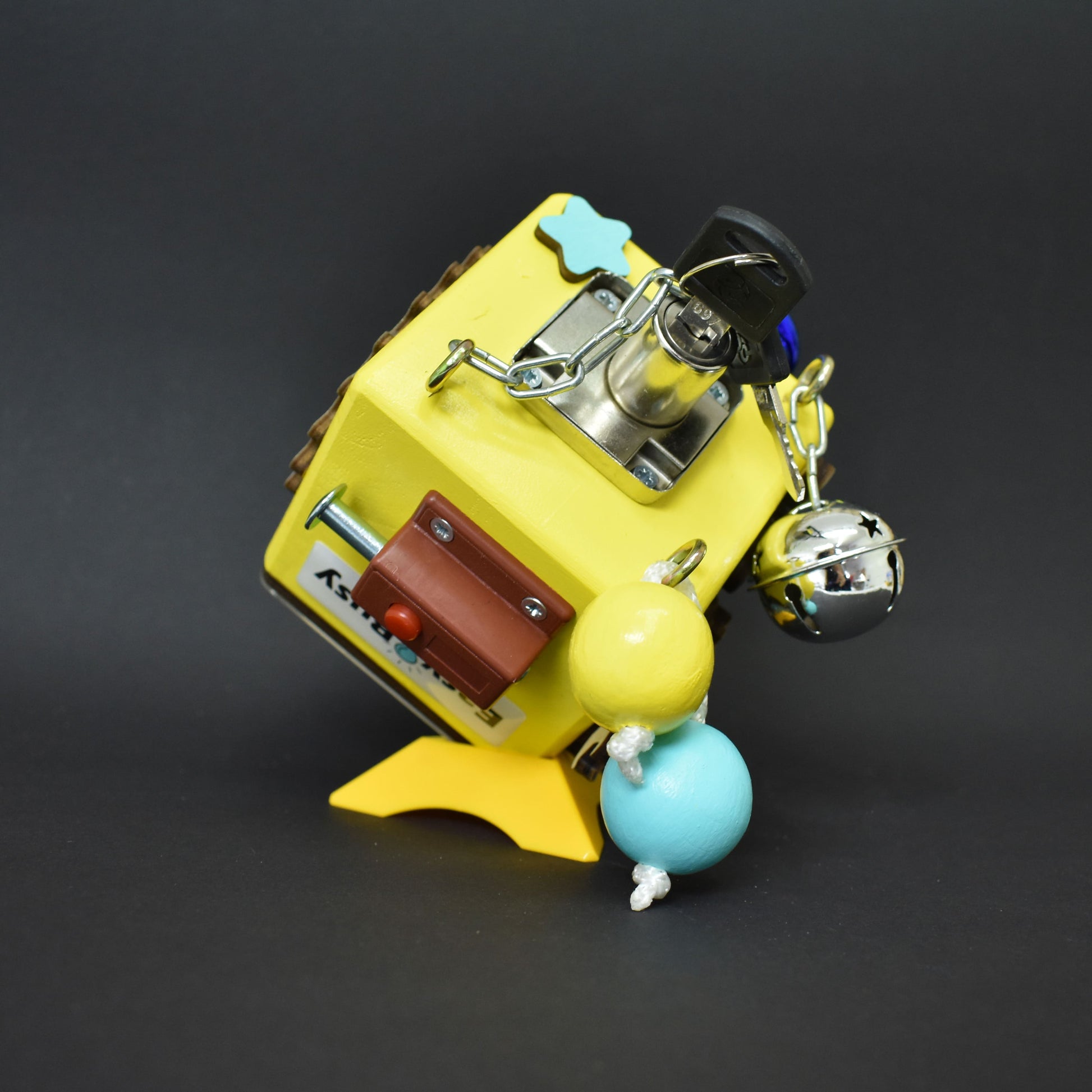 Travel-friendly busy cube with bright yellow design