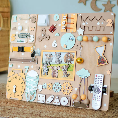 Close-up of removable magnetic animals on a farm sensory play panel