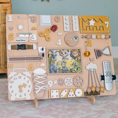 Toddler interacting with a wooden jungle-themed busy board