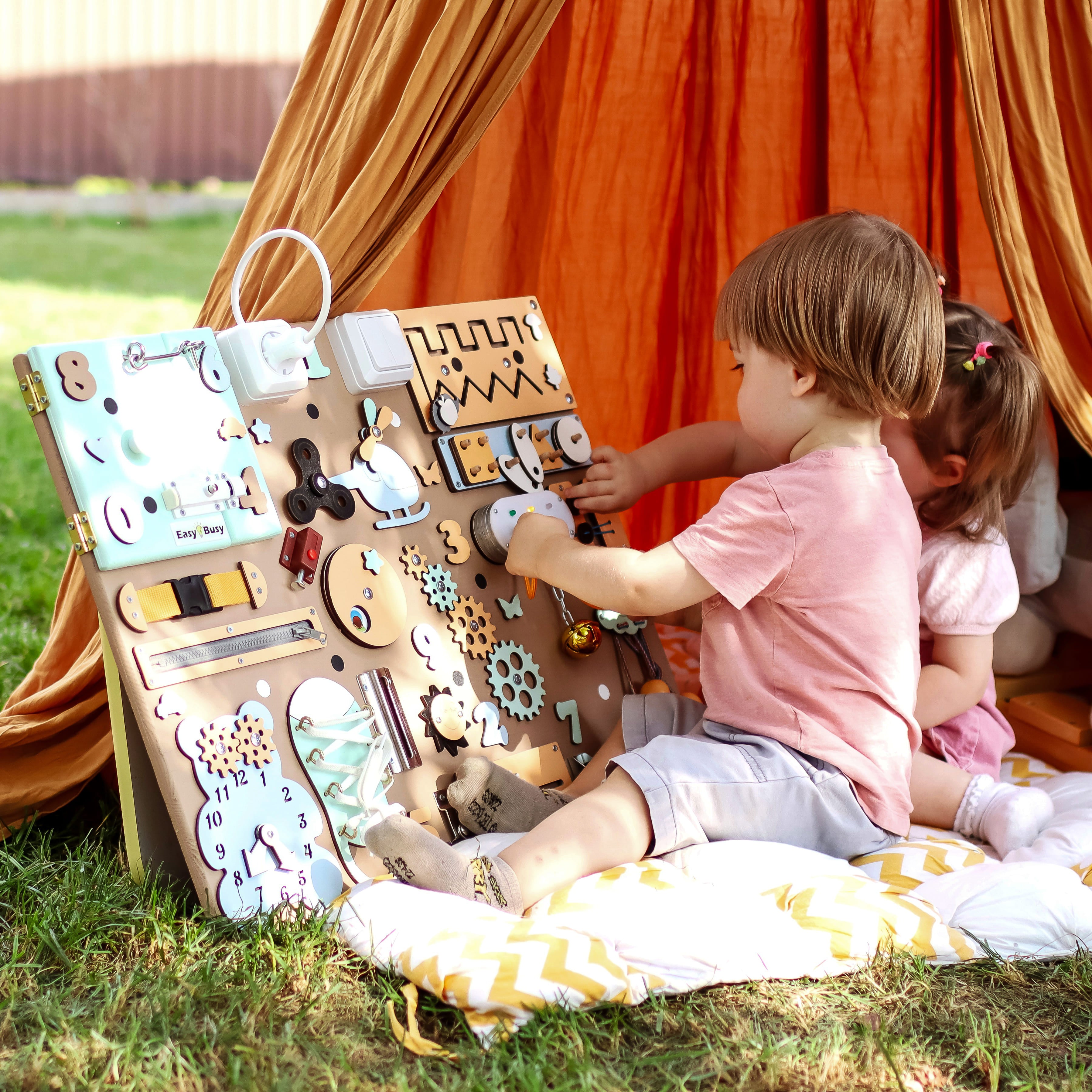 Engaging interactive busyboard for toddlers with locks, zippers, gears, and switches, designed to enhance fine motor skills and creativity through hands-on play