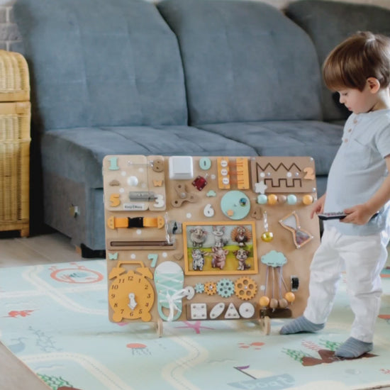 Toddler engaging with a Montessori-inspired farm sensory play board