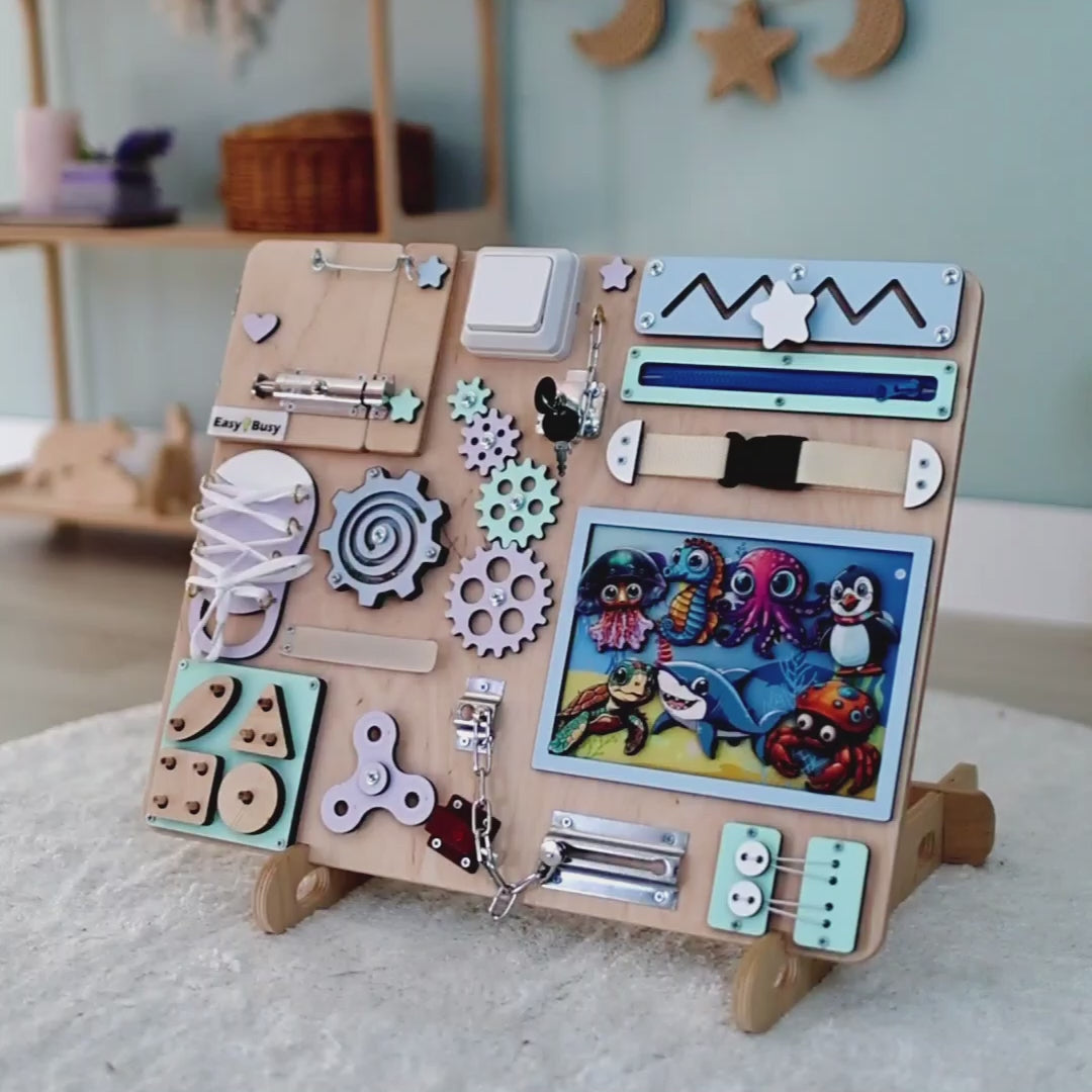 Close-up of removable magnetic fish, dolphins, and jellyfish on a wooden busy board