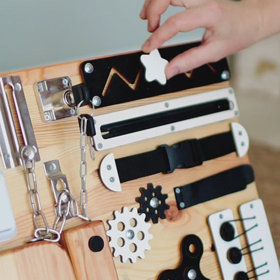 Toddler sensory board with switch, lock, and spinner