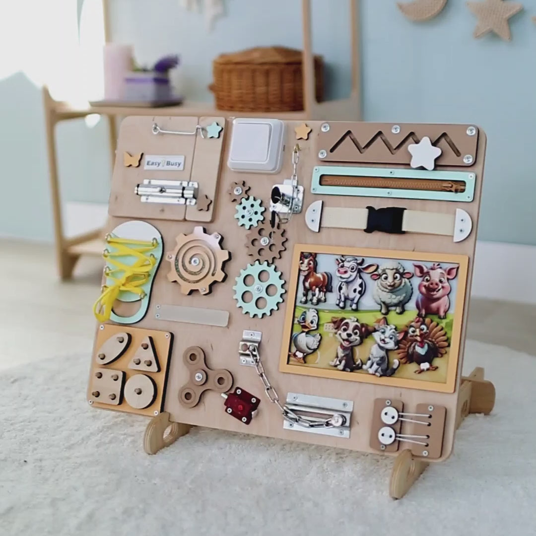 Montessori interactive play board with cows, horses, and chickens