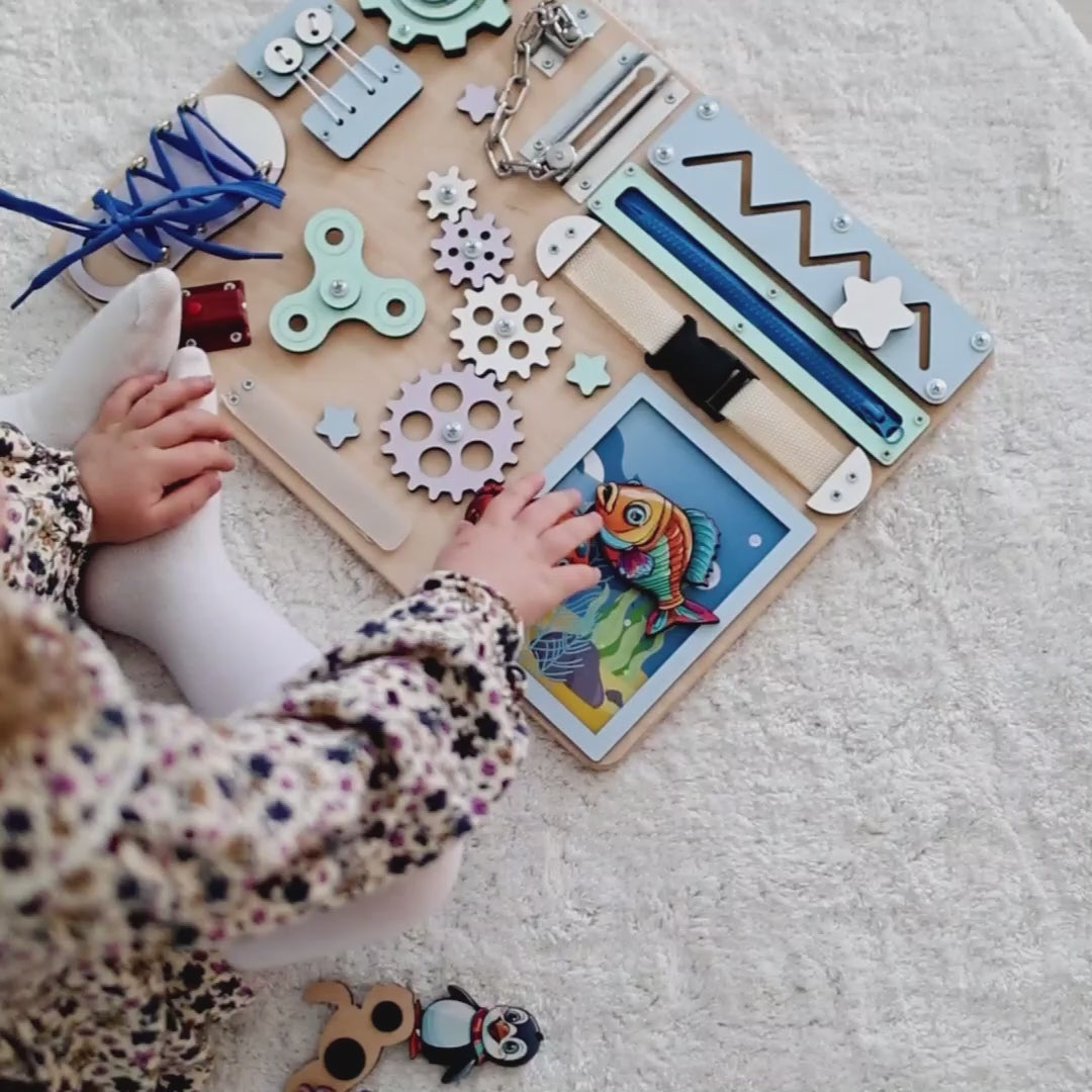 Montessori sensory play board featuring dolphins, turtles, and sharks