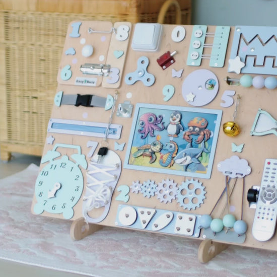 Close-up of removable magnetic fish, stingrays, and crabs on a wooden busy board
