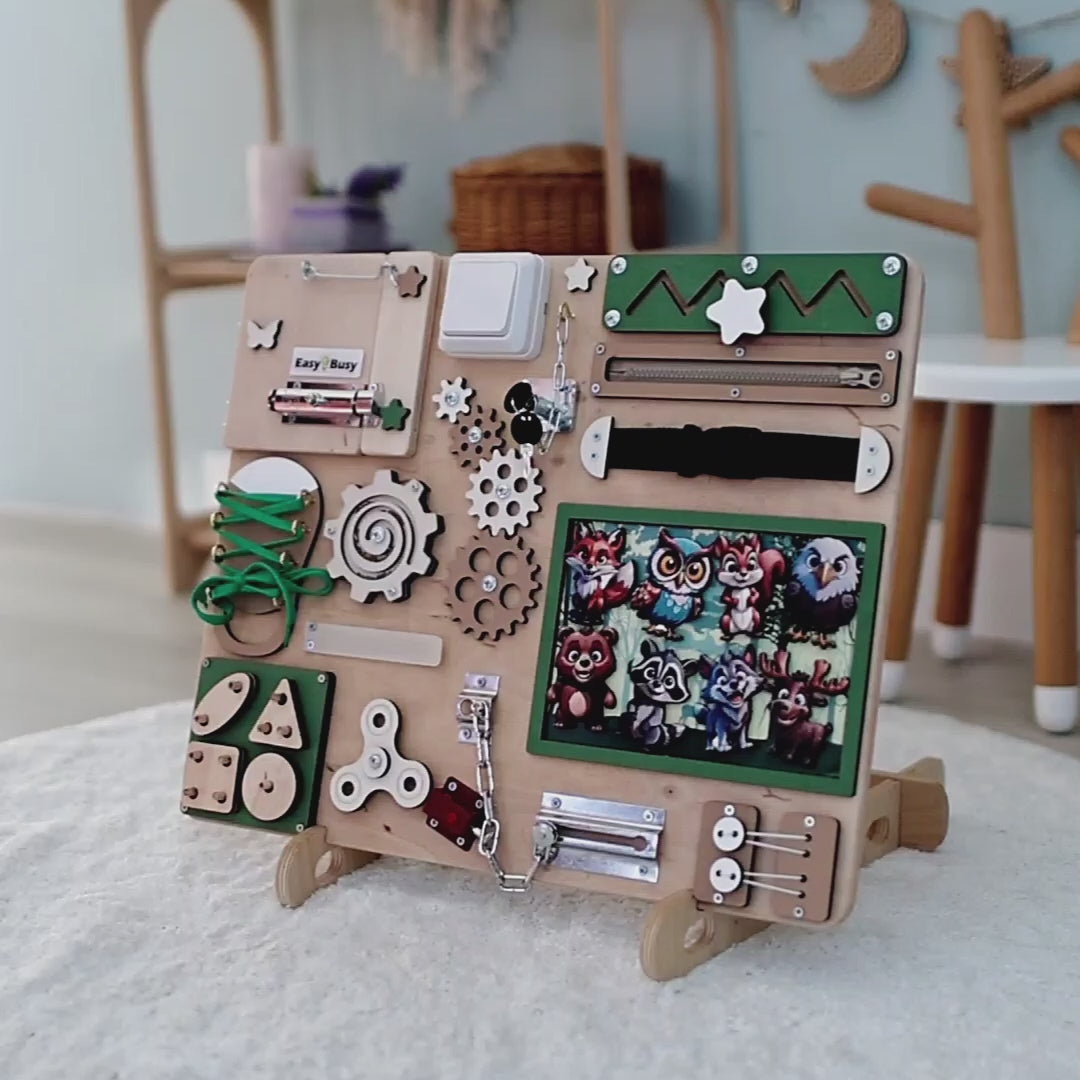 Toddler playing with an interactive Montessori forest busy board