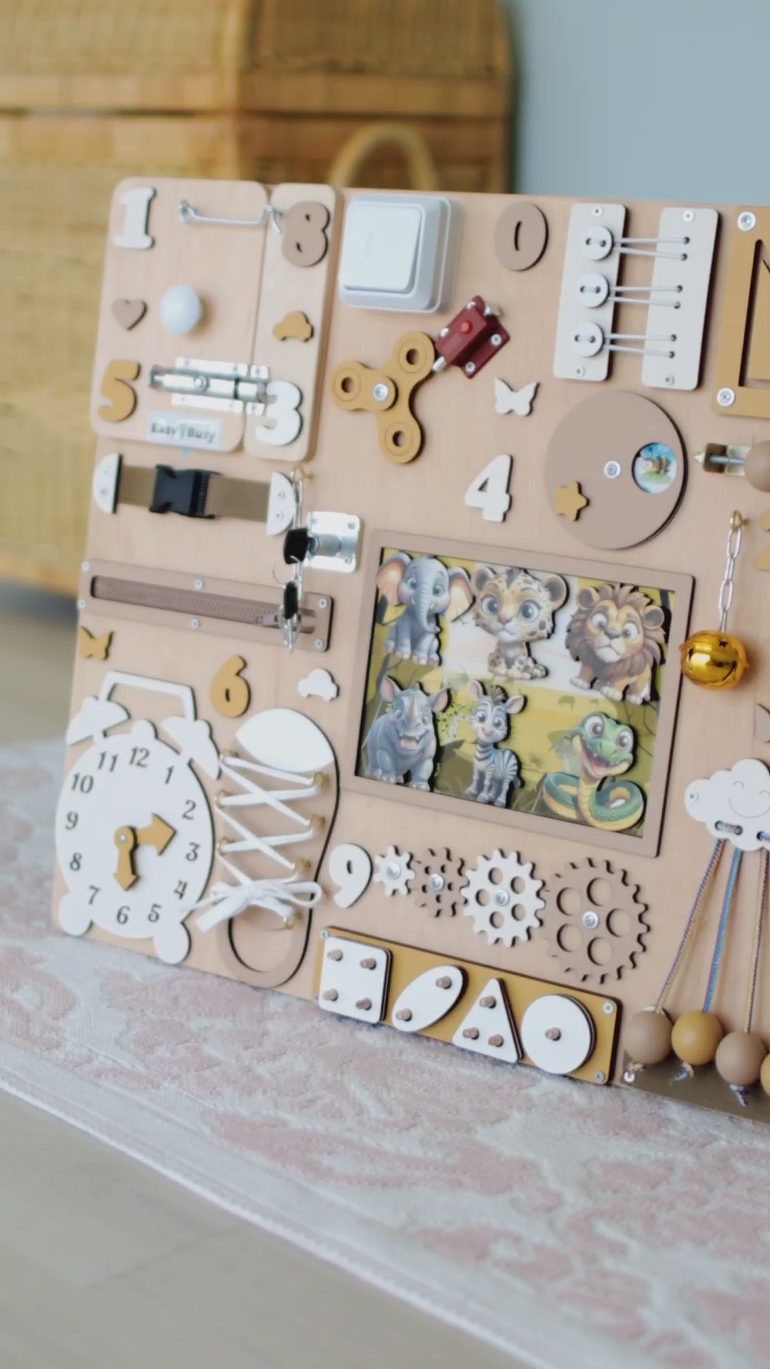Toddler playing with an interactive Montessori safari sensory play board